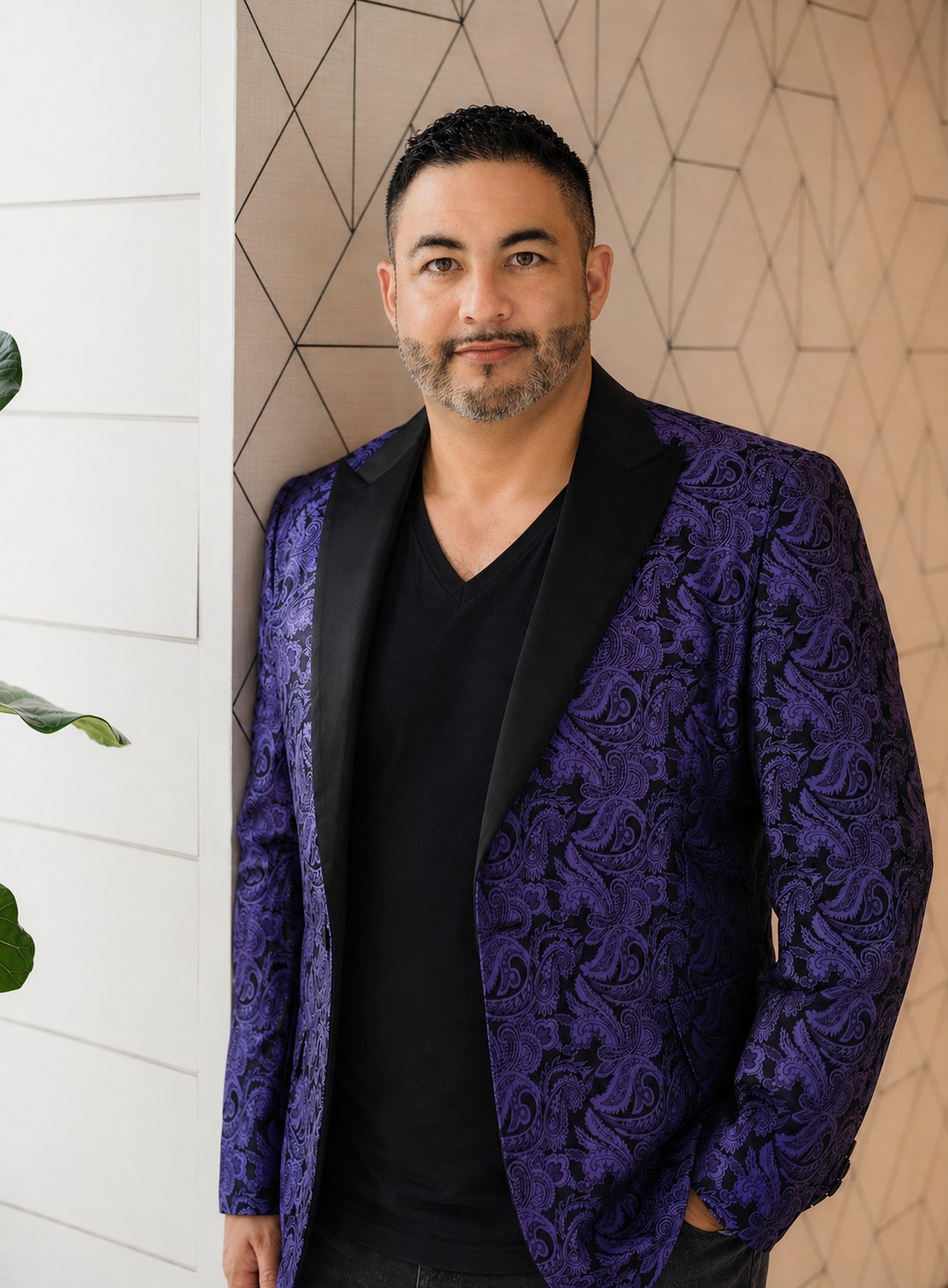Glenn Lewis, DJ ANIMALE and owner of Music Masterz, wearing a purple patterned jacket.
