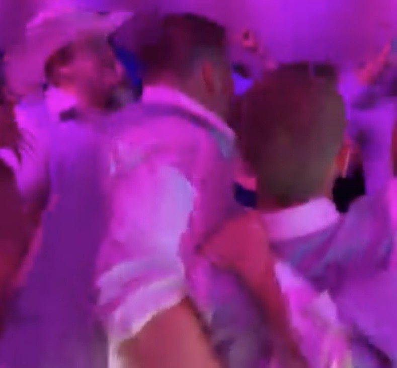 Guests dancing under purple lights at the Anderson Wedding