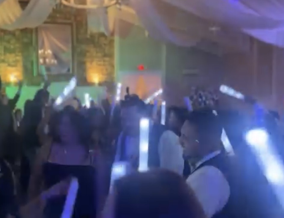 Glow stick celebration on the dance floor at the Olivera Wedding